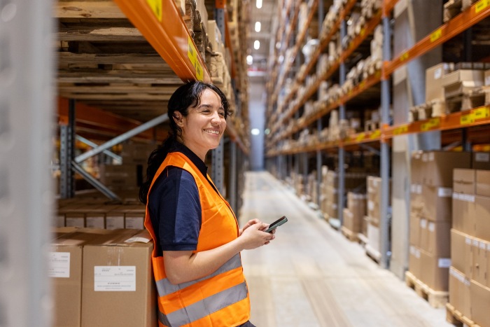 The woman at LA Machinery Moving smiling as they create a Lean warehouse using the 5s method